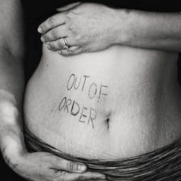 Exposed stomach with out of order written on it