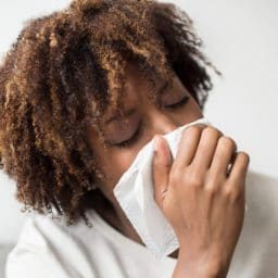 Woman with a tissue to her nose