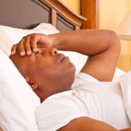 Frustrated man in bed with insomnia.