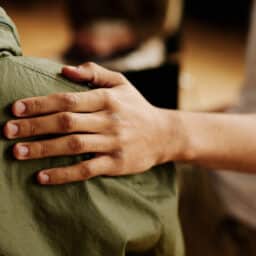 Close up of a hand on a should, support concept