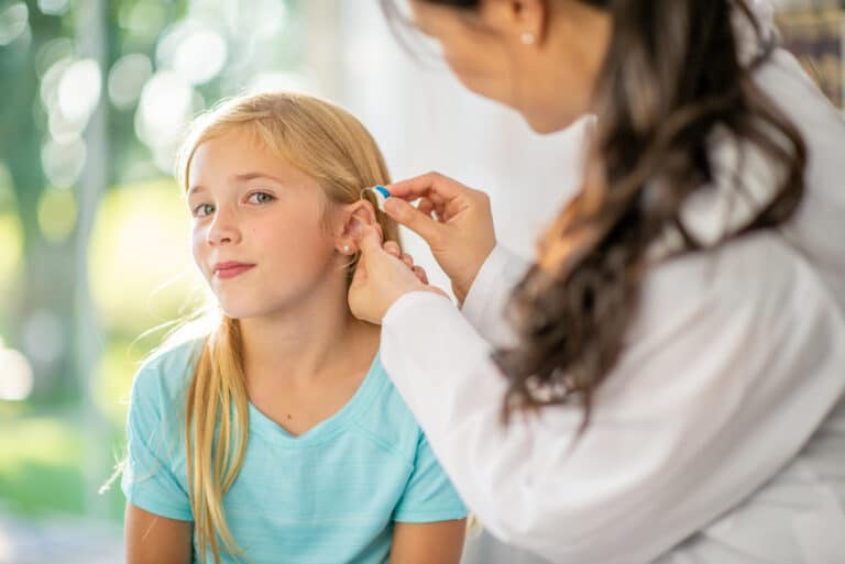 Young girl gets hearing aid