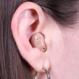 Closeup of ear with hearing aid in it