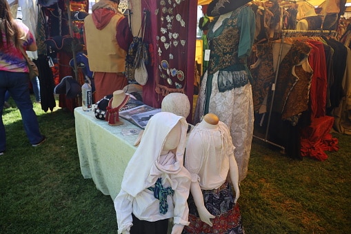 A booth of artwork, costuming and other paraphernalia at a renaissance faire. A booth of artwork, costuming and other paraphernalia at a renaissance faire.
